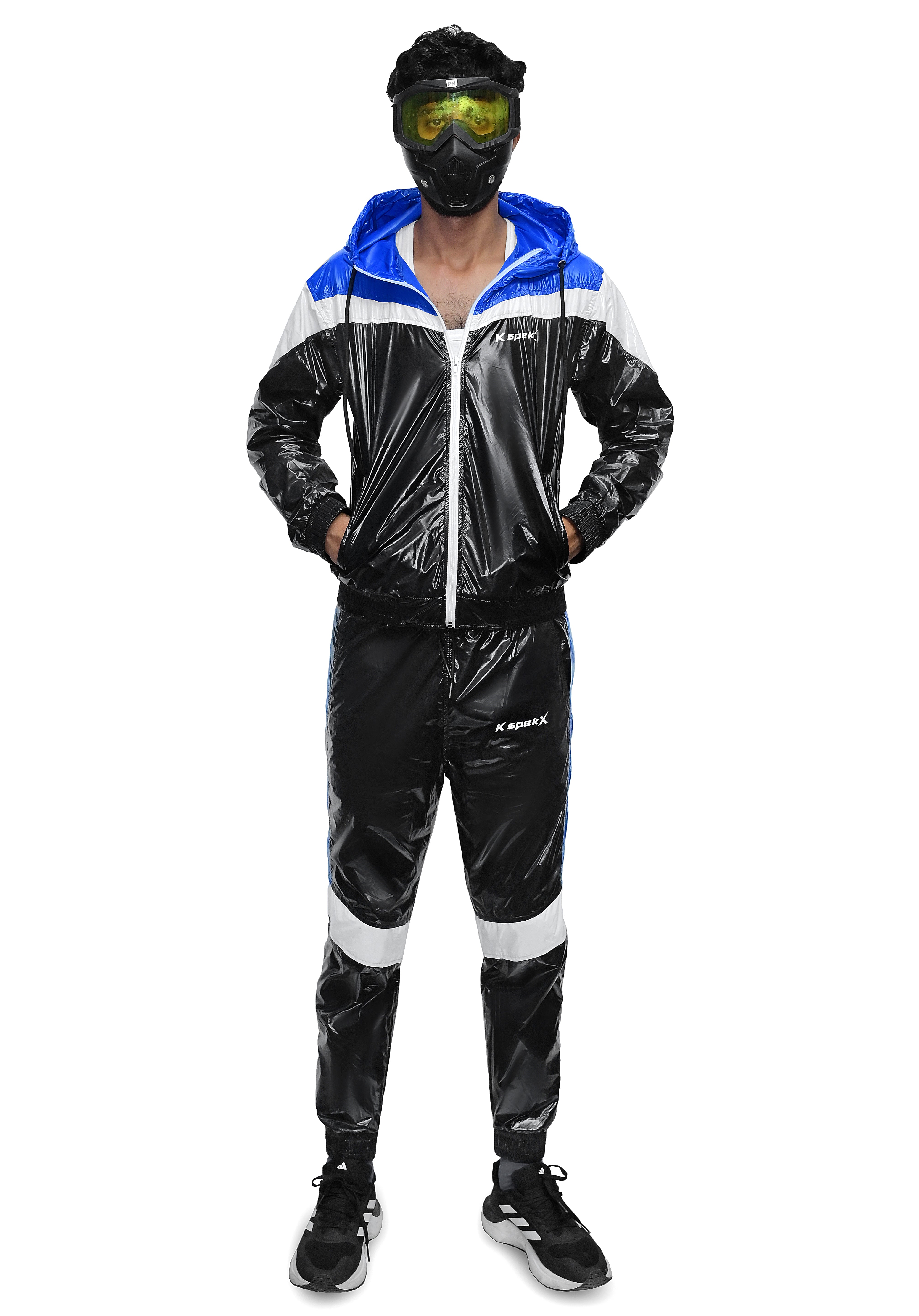 A person modeling a shiny black, white, and blue hooded tracksuit with a glossy vinyl-like finish, standing against a plain white background. The tracksuit has a blue hood lining, white shoulder panels, and white side stripes on the pants.